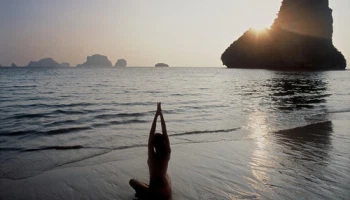 Woman Practicing Yoga on Beach