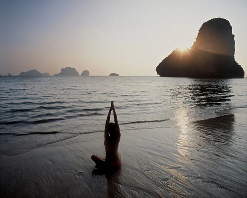 Woman Practicing Yoga on Beach